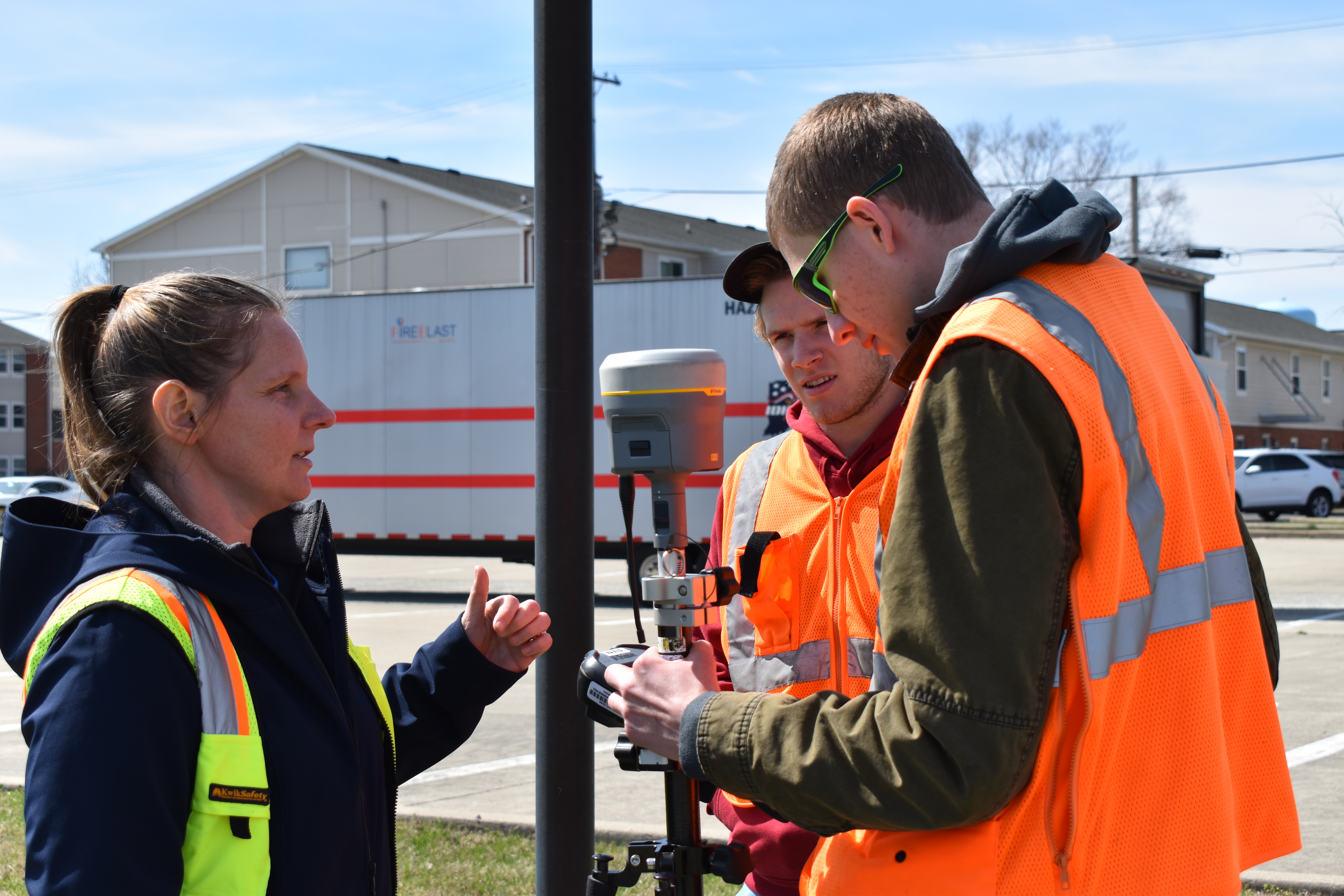 Jessica Hess observes her Surveying Technology students in the field